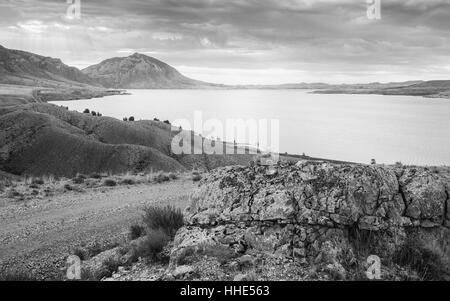 The reservoir and environs including the rugged, arid undulating landscape around the Shoshone river at dawn near Cody, Wyoming, US Stock Photo