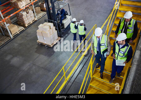 Forklift, managers and workers in distribution warehouse Stock Photo