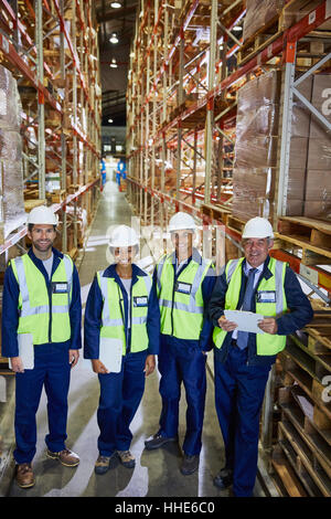 Portrait smiling workers in distribution warehouse Stock Photo
