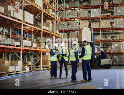 Workers meeting and talking in distribution warehouse Stock Photo