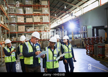 Manager and workers talking in distribution warehouse Stock Photo