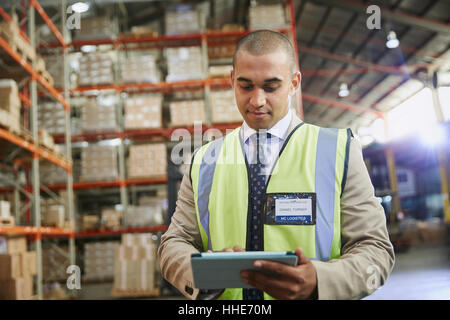 Manager using digital tablet in distribution warehouse Stock Photo