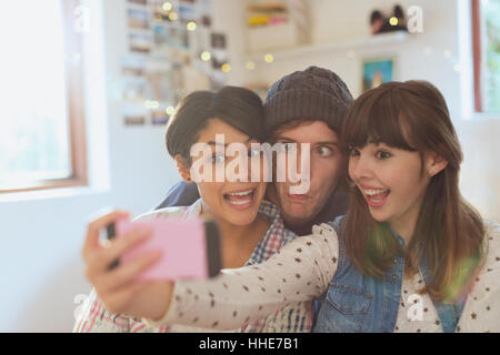 Playful young friends taking selfie making silly faces Stock Photo