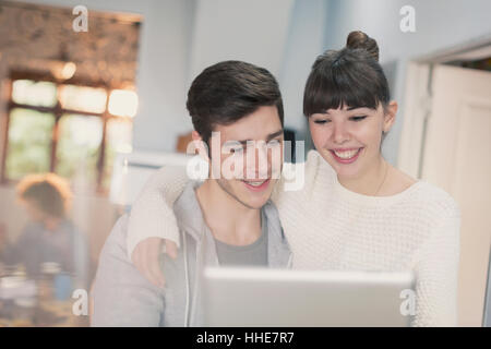 Smiling young couple using digital tablet Stock Photo