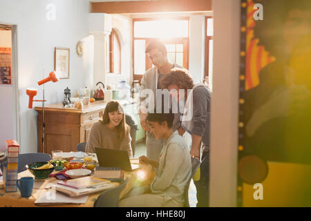 Young friends college students studying at laptop at table Stock Photo