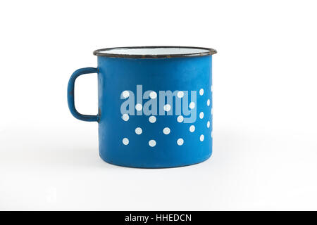Old blue enamel cup with white dots isolated on white background Stock Photo
