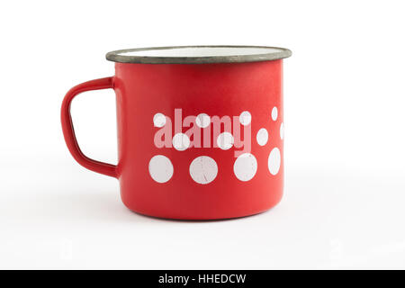 Old red enamel cup with white dots isolated on white background Stock Photo