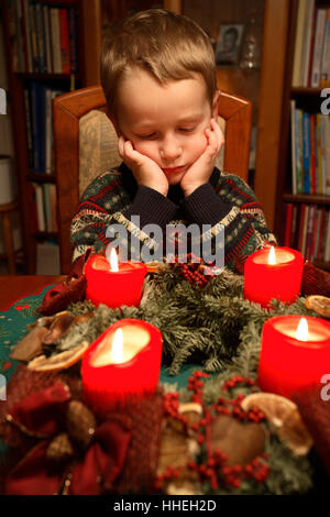 Little boy sitting in front of advent wreath Stock Photo