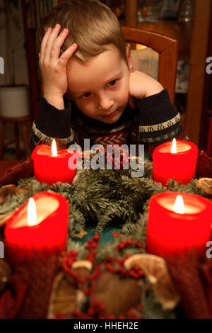 Little boy sitting in front of advent wreath Stock Photo