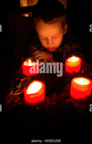 Little boy sitting in front of advent wreath Stock Photo