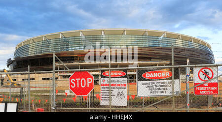 Construction site signs on a security fence outside the new Stadium Stock Photo
