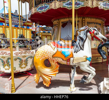 Colorful Horse on a Carousel in a park Stock Photo