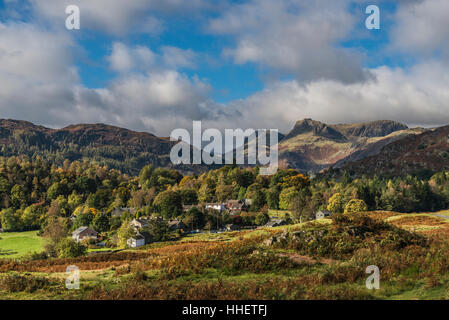 The Langdale Pikes and Elterwater village in Autumn Stock Photo