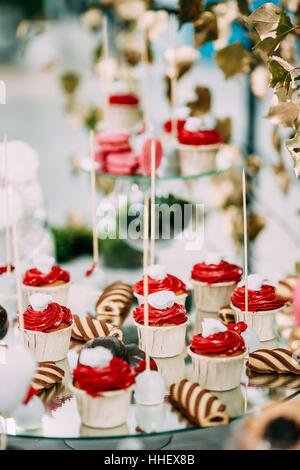 Dessert Sweet Tasty Cupcakes And Cookies In Candy Bar On Table. Delicious Sweet Buffet. Wedding Decorations Stock Photo