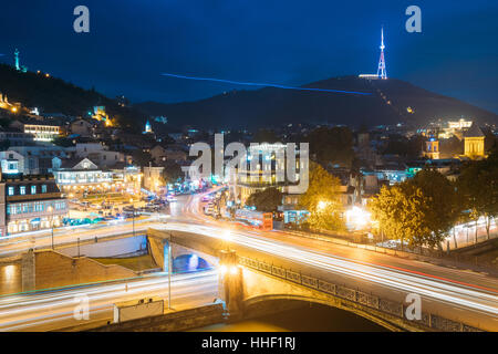 Tbilisi Georgia. Holy Mountain Mtatsminda Mount In Evening Night Illumination Under Blue Sky. On Top Of Mountain Is 277.4 M Tall Tower, A Park With A Stock Photo