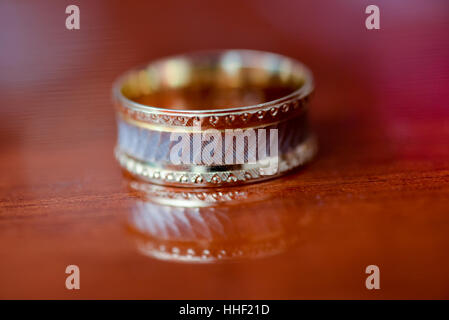 Wedding ring placed on the table in light side Stock Photo