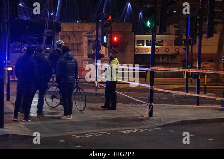 London, UK. 19th Jan, 2017. A suspected WWII unexploded bomb found during marine engineering works has closed the Embankment on the River Thames between Westminster and Embankment tube stations, outside the National Liberal Club in Whitehall Place. Police sources said it was ' a public safety issue' whilst a nearby workman said that it was believed that an unexploded bomb from WWII had been found in the river. Traffic was diverted and cyclists were denied use of their super highway in the name of safety. Credit: Peter Hogan/Alamy Live News Stock Photo