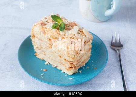 Piece of cake Napoleon on green plate Stock Photo - Alamy