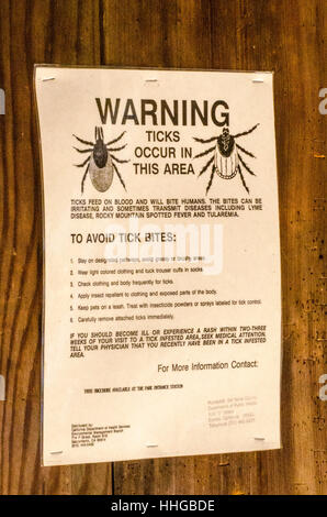 A tick warning sign at Richardson Grove State Park near Garberville California in the old growth redwood forest Stock Photo