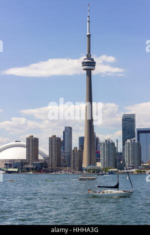 TORONTO, CANADA - CN Tower and skyline view with boat passing by the Ontario lake in a sunny morning Stock Photo