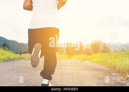 Man running   and nature background view.Back of a man Stock Photo