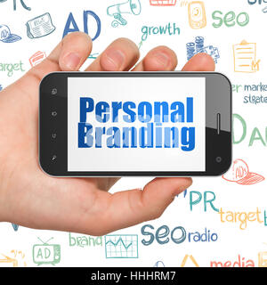 Advertising concept: Hand Holding Smartphone with Personal Branding on display Stock Photo