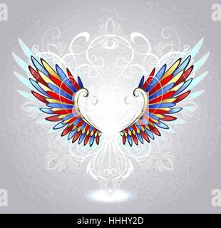 Stained glass wings of red, blue and yellow glass , decorated with a white pattern on a light background. Stock Vector