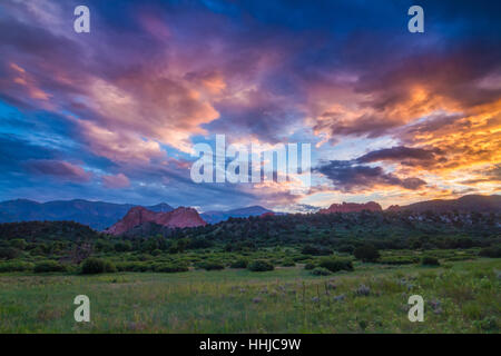 An incredible sunset covers the rocky landscape of Garden of the Gods and Pikes Peak in Colorado Springs, Colorado Stock Photo