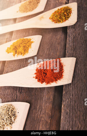 mix of spices on wooden spoons Stock Photo