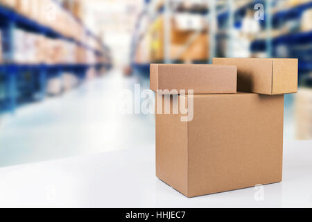 blank cardboard boxes on the table in warehouse with copy space Stock Photo