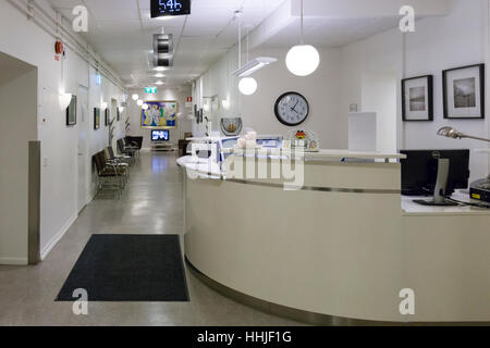 Empty and unmanned hospital reception desk area and waiting room  Model Release: No.  Property Release: No. Stock Photo