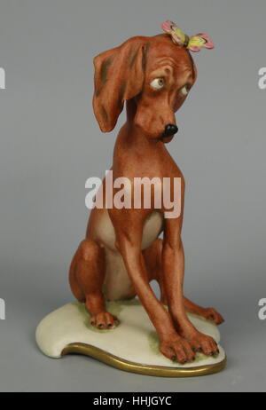 Capodimonte Giuseppe Cappe Porcelain Figurine 99069 Dog with Butterfly Stock Photo