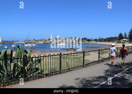 People walk along the path next to Brighton Beach Wollongong. Stock Photo