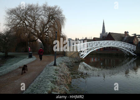A dog walker makes their way along the River Great Ouse at Godmanchester on a frosty morning in Cambridgeshire. Stock Photo