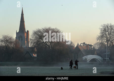 Dog walkers make their way across parkland along the banks of the River Great Ouse at Godmanchester on a frosty morning in Cambridgeshire. Stock Photo