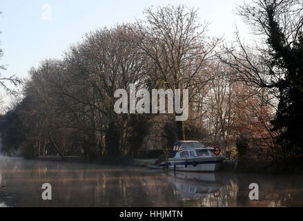 A river cruiser is moored along the River Great Ouse at Godmanchester on a frosty morning in Cambridgeshire. Stock Photo