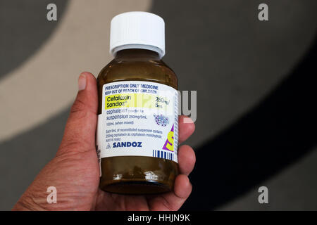 Hand Holding Cefalexin Sandoz antibiotic Stock Photo