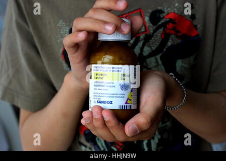 Hand Holding Cefalexin Sandoz antibiotic Stock Photo