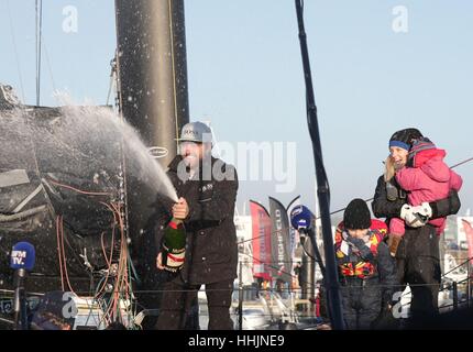 British sailor Alex Thomson is watched by his wife Kate, son Oscar and daughter Georgia, as he celebrates with champagne after finishing second in the Vendee Globe race at Les Sables d'Olonne, western France. Stock Photo