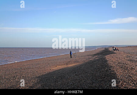 A sea angler on the shingle beach at Cley next the Sea, Norfolk, England, United Kingdom. Stock Photo