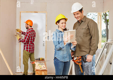 Architects and craftsmen renovating in teamwork at construction site Stock Photo