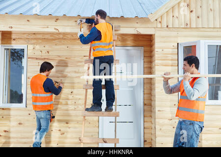 Team of carpenters working on new woodhouse Stock Photo