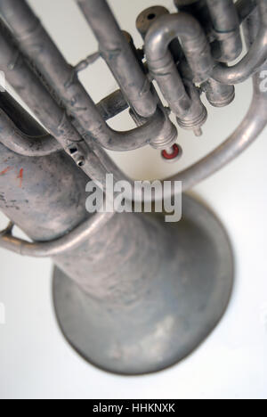 A vintage brass trumpet on a white table top, Portsmouth, Hampshire, UK. Stock Photo