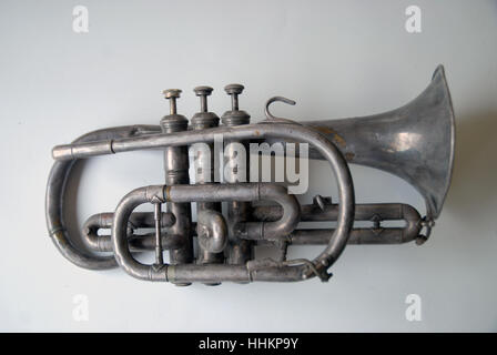 A vintage brass trumpet on a white table top, Portsmouth, Hampshire, UK. Stock Photo