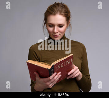 young pretty girl reading a book. Study english language concept Stock Photo