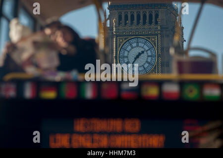 A foreshortened perspective of a tour bus with tourists reading their London map and in the background, the clockface of Elizabeth Tower of the British parliament, on 17th January 2017, in London England. Stock Photo