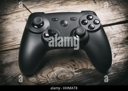video game controller on a wooden table. joystick Stock Photo