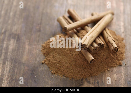 ceylon cinnamon sticks and powder on wooden background Stock Photo