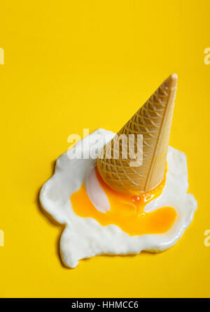 Ice cream cone dropped concept with fried egg Stock Photo