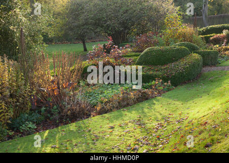 Fawley House Garden. November 2016. Tiered 2.5 acre garden with lawns, mature trees, formal hedging, stream and gravel pathways. Stock Photo